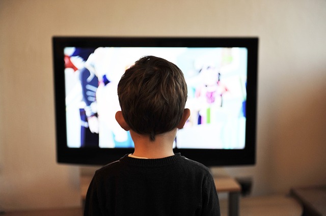 kid sitting in front of tv